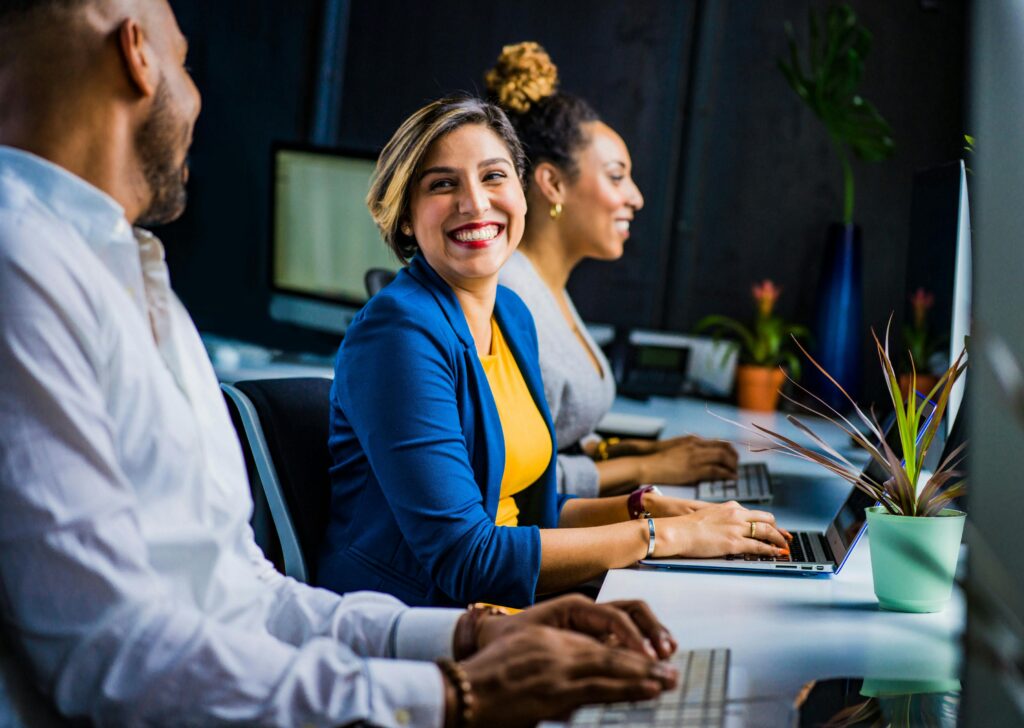 people sitting at a table working on computers